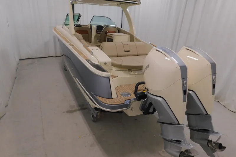 Slide: The Image of 2024 Chris-Craft Launch 31 GT boat with dual outboard engines in a showroom. - 10