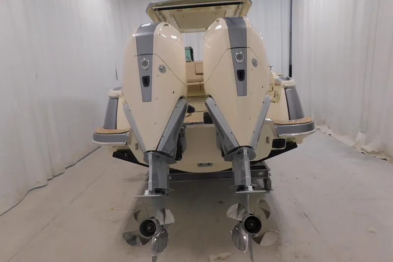 Slide: The Image of 2024 Chris-Craft Launch 31 GT boat with dual outboard engines in a showroom. - 2