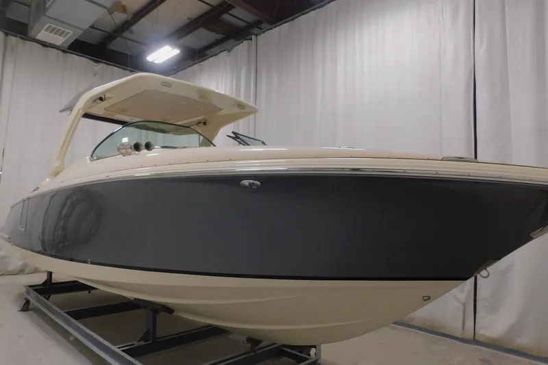 Slide: The Image of 2024 Chris-Craft Launch 31 GT boat in indoor showroom, side view. - 4