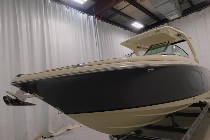 Slide: The Image of 2024 Chris-Craft Launch 31 GT boat in showroom, side view. - 6
