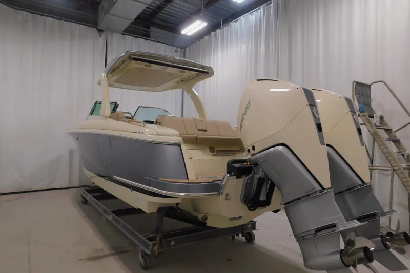 Slide: The Image of 2024 Chris-Craft Launch 31 GT boat with dual Mercury outboard engines in a showroom. - 7