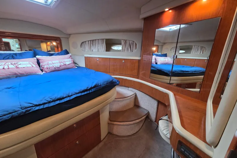 Slide: The Image of Luxurious 2000 Sea Ray 420 Aft Cabin interior with cozy bed and elegant wood finishes. - 11
