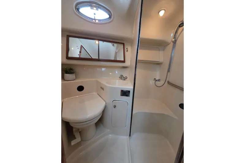Slide: The Image of Bathroom interior of 2000 Sea Ray 420 Aft Cabin yacht, featuring shower and toilet. - 12