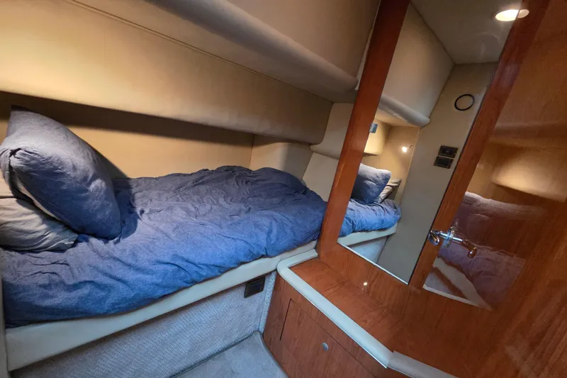 Slide: The Image of Cozy cabin interior of 2000 Sea Ray 420 Aft Cabin yacht with blue bedding. - 13