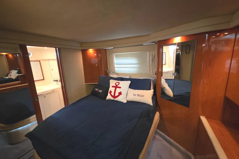 Slide: The Image of Luxurious 2000 Sea Ray 420 Aft Cabin bedroom with nautical-themed decor. - 19