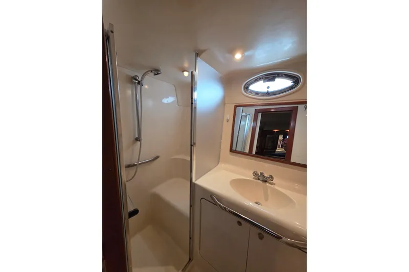 Slide: The Image of Bathroom interior of 2000 Sea Ray 420 Aft Cabin yacht, featuring shower and sink. - 20