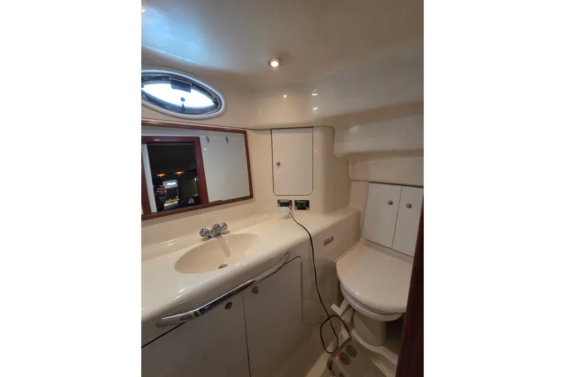 Slide: The Image of Bathroom interior of 2000 Sea Ray 420 Aft Cabin yacht, featuring sink and mirror. - 21