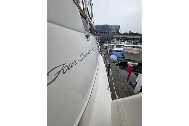 Slide: The Image of 2000 Sea Ray 420 Aft Cabin yacht docked at marina, side view. - 22