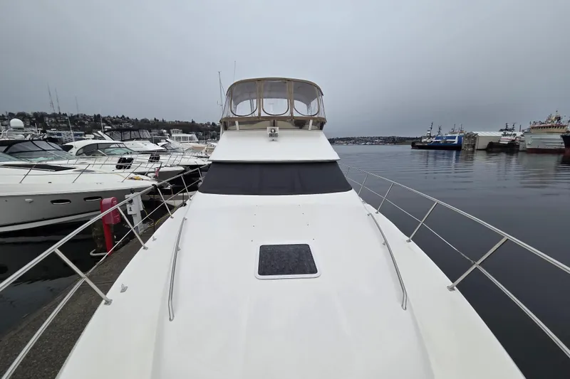 Slide: The Image of 2000 Sea Ray 420 Aft Cabin yacht docked at marina, overcast sky. - 23