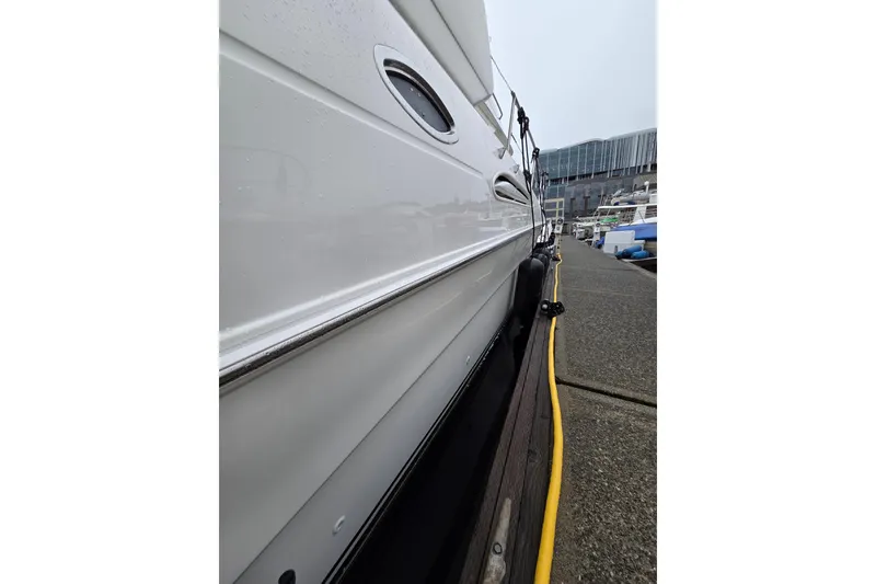 Slide: The Image of Side view of a 2000 Sea Ray 420 Aft Cabin yacht docked at a marina. - 27