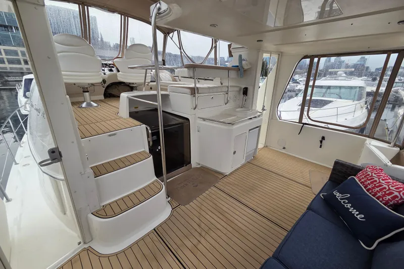 Slide: The Image of 2000 Sea Ray 420 Aft Cabin yacht interior with seating, helm, and kitchenette. - 3