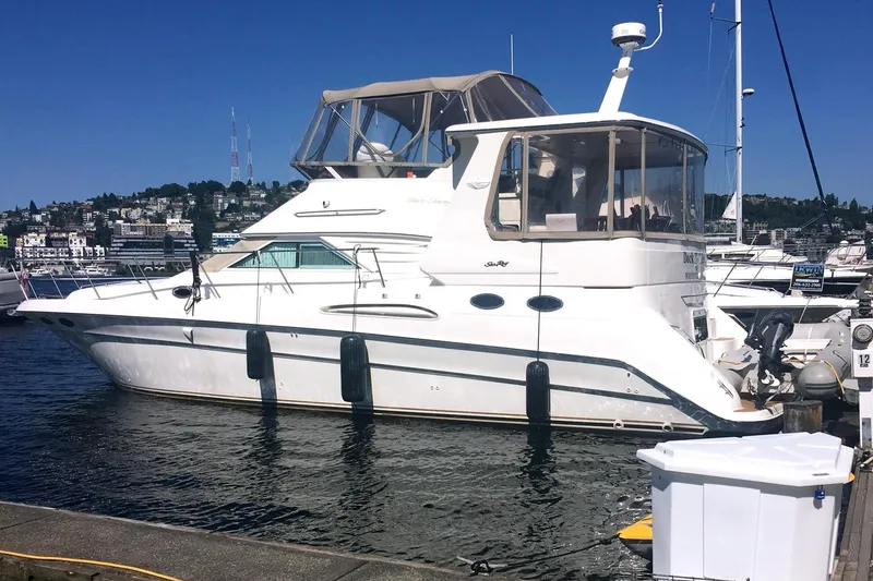 Slide: The Image of 2000 Sea Ray 420 Aft Cabin yacht docked in a marina under clear blue skies. - 30