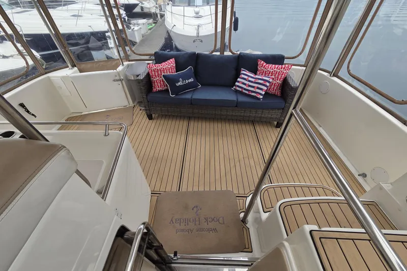 Slide: The Image of Aft deck of 2000 Sea Ray 420 Aft Cabin with seating and nautical decor. - 5