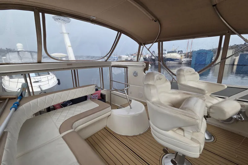 Slide: The Image of Interior of 2000 Sea Ray 420 Aft Cabin yacht with luxurious seating and marina view. - 7