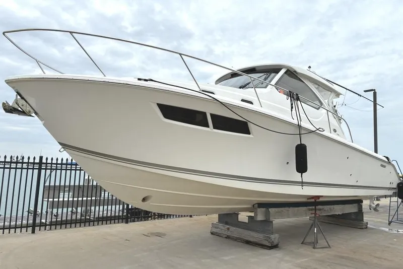 The Image of 2023 Pursuit OS 355 Offshore boat on dry dock, showcasing sleek design and modern features. - 0