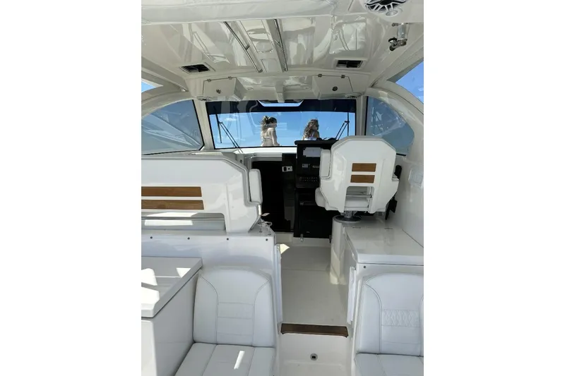 Slide: The Image of 2023 Pursuit OS 355 Offshore boat with bird flying over ocean wake. - 10