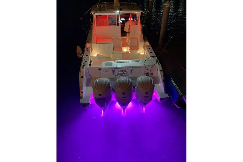 Slide: The Image of 2023 Pursuit OS 355 Offshore boat interior with white seating and modern helm. - 11