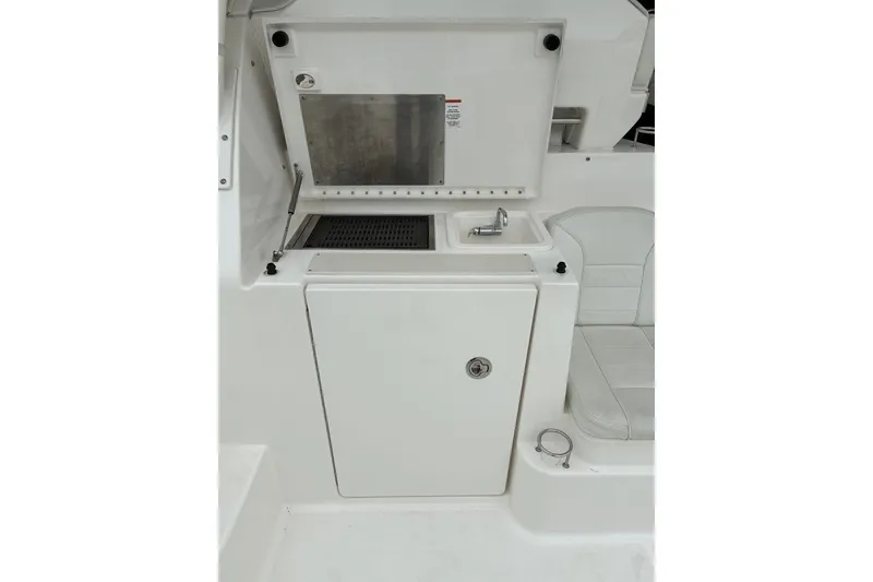 Slide: The Image of 2023 Pursuit OS 355 Offshore boat interior with sink and storage compartment. - 13