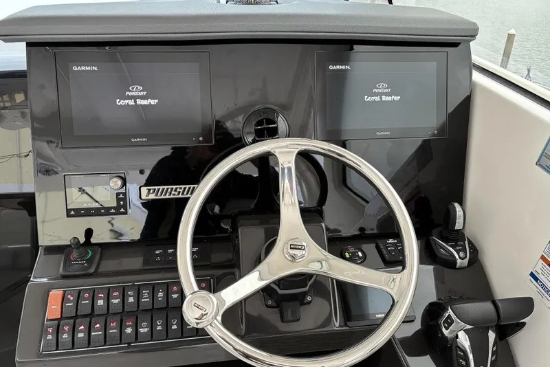 Slide: The Image of 2023 Pursuit OS 355 Offshore helm with dual Garmin displays and modern controls. - 14