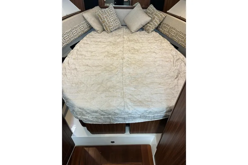 Slide: The Image of 2023 Pursuit OS 355 Offshore cabin with cozy bed and decorative pillows. - 19
