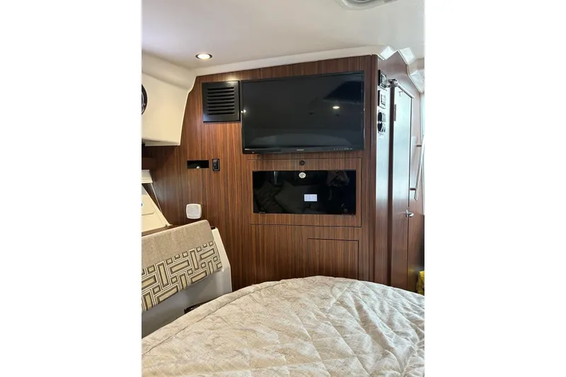 Slide: The Image of Interior of 2023 Pursuit OS 355 Offshore boat with TV and wood paneling. - 20