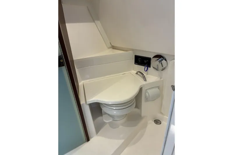 Slide: The Image of 2023 Pursuit OS 355 Offshore boat bathroom with compact toilet and modern fixtures. - 22