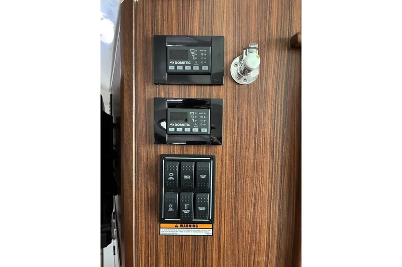 Slide: The Image of Control panel on 2023 Pursuit OS 355 Offshore boat with Dometic displays and switches. - 27