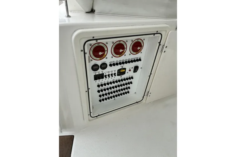 Slide: The Image of Control panel of 2023 Pursuit OS 355 Offshore boat with switches and gauges. - 30