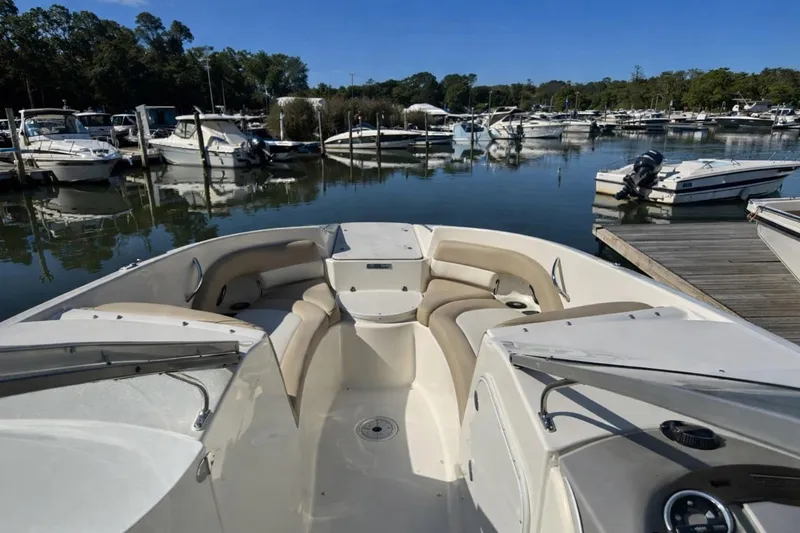 Slide: The Image of 2017 Stingray 234 LR boat docked in a marina with other boats. - 3