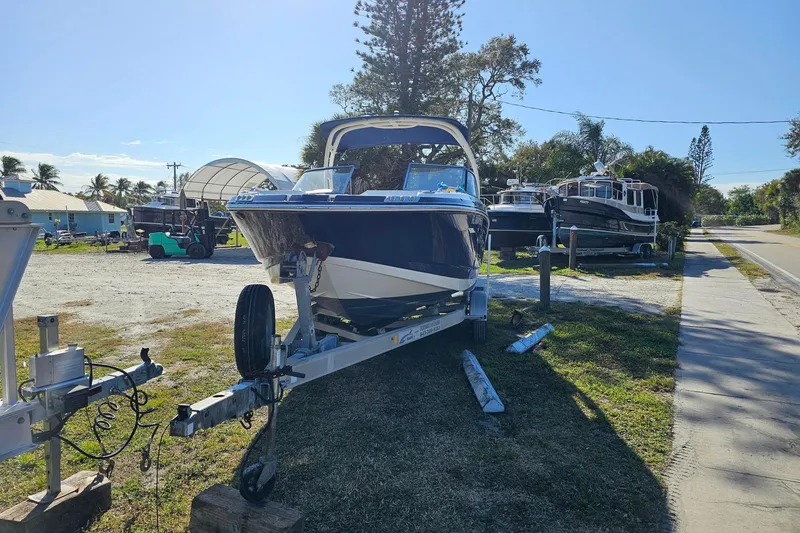 Slide: The Image of Chaparral 230 Suncoast 2008 boat on trailer in sunny outdoor setting. - 1