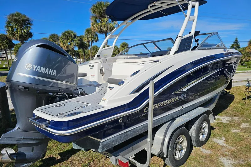 Slide: The Image of 2008 Chaparral 230 Suncoast boat with Yamaha engine on trailer, palm trees in background. - 3