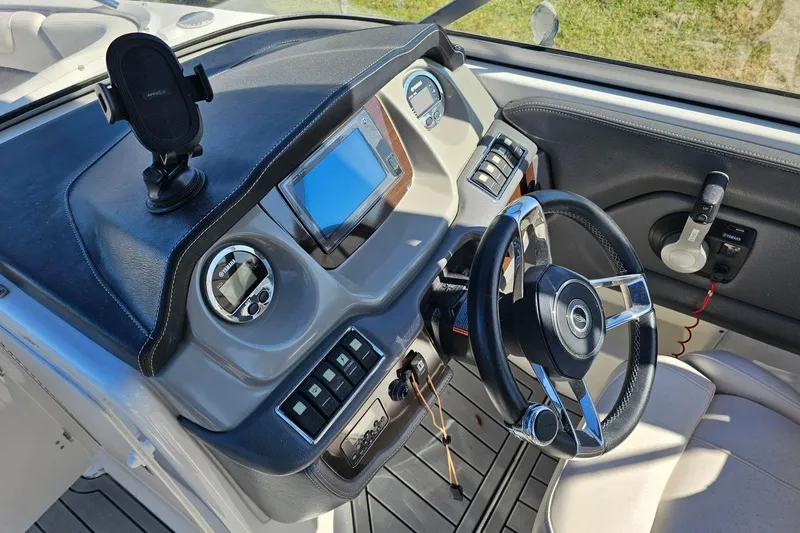 Slide: The Image of Cockpit of 2008 Chaparral 230 Suncoast boat with steering wheel and control panel. - 7