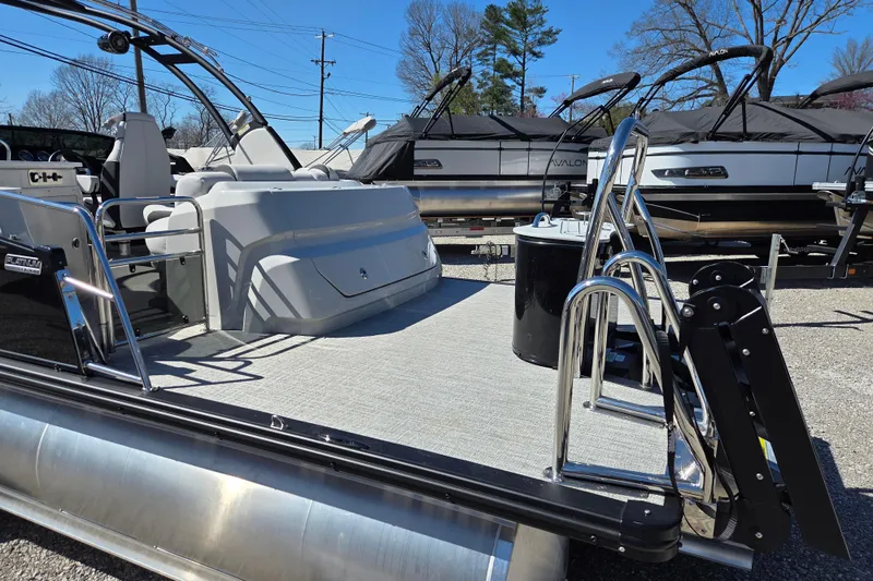 Slide: The Image of 2026 Avalon Platinum Catalina 2785 Elite Windshield pontoon boat, docked with sleek design. - 7