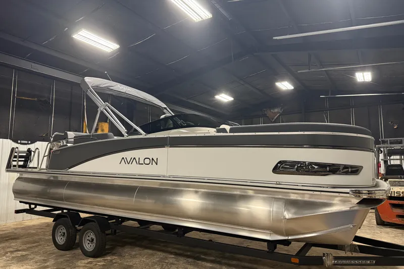 Slide: The Image of 2026 Avalon Catalina Quad Lounger Shift Windshield pontoon boat in indoor showroom. - 13