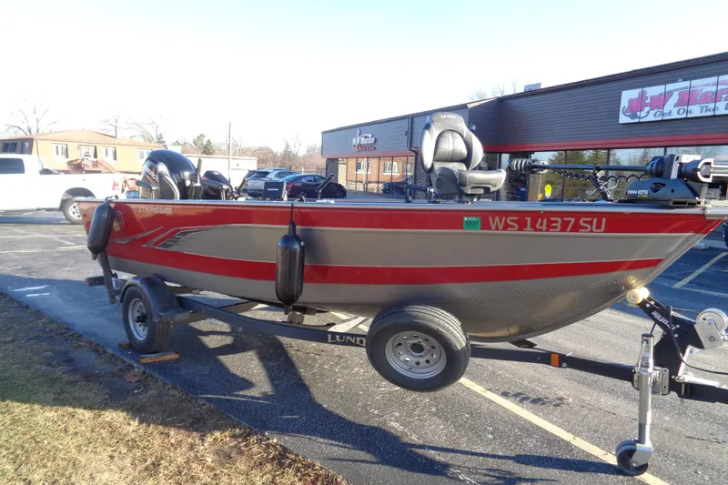 Slide: The Image of 2021 Lund 1775 Pro Guide fishing boat on trailer in parking lot. - 1