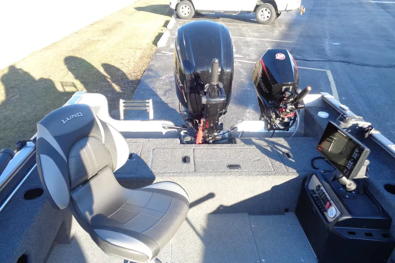Slide: The Image of 2021 Lund 1775 Pro Guide boat interior with seating, motor, and control panel. - 13