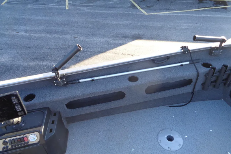 Slide: The Image of 2021 Lund 1775 Pro Guide boat interior with rod holders and control panel. - 17
