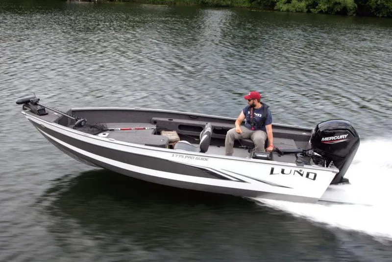 Slide: The Image of Manufacturer Provided Image: 2021 Lund 1775 Pro Guide boat on water with Mercury outboard motor. - 19