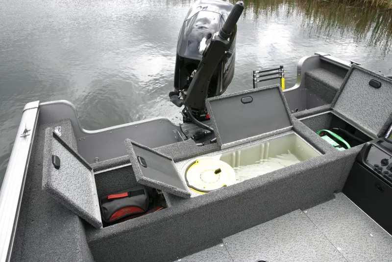 Slide: The Image of Manufacturer Provided Image: 2021 Lund 1775 Pro Guide fishing boat with open storage compartments and outboard motor. - 24