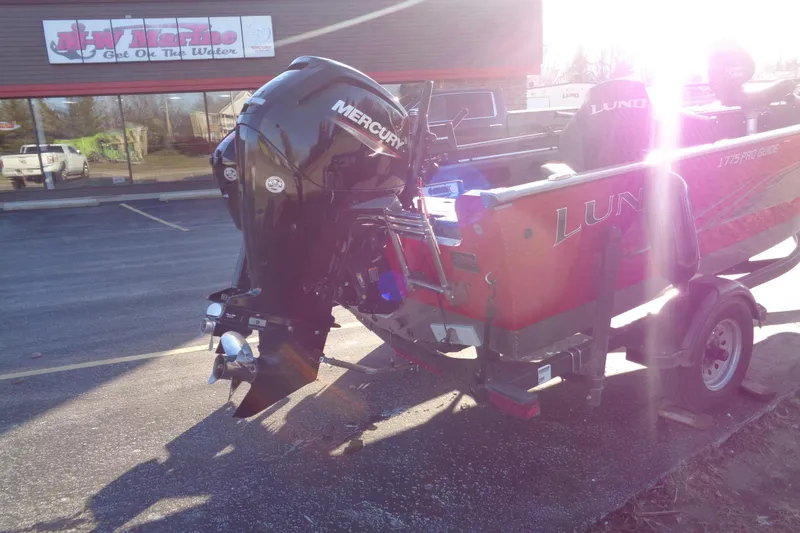 Slide: The Image of 2021 Lund 1775 Pro Guide boat with Mercury engine in parking lot. - 3