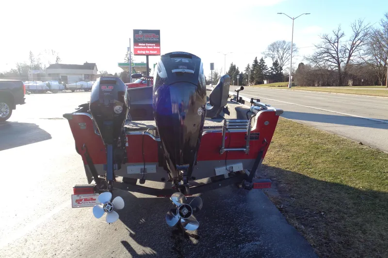 Slide: The Image of 2021 Lund 1775 Pro Guide boat with dual outboard motors on a sunny day. - 4
