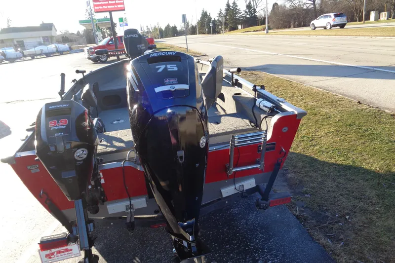 Slide: The Image of 2021 Lund 1775 Pro Guide boat with dual Mercury outboard motors on a roadside. - 6