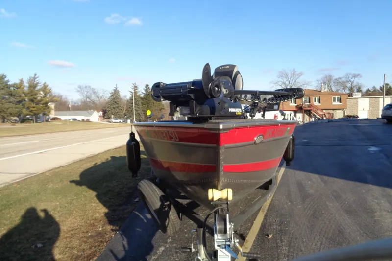 Slide: The Image of 2021 Lund 1775 Pro Guide boat on trailer, parked on roadside. - 7