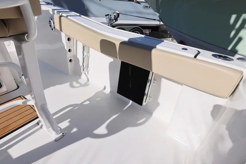 Slide: The Image of 2022 Tidewater 220 CC Adventure boat interior with cushioned seating and sleek design. - 11