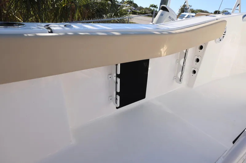 Slide: The Image of 2022 Tidewater 220 CC Adventure boat interior detail with beige trim and storage compartment. - 12