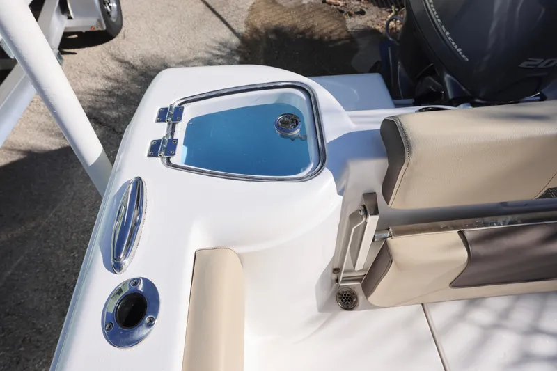 Slide: The Image of 2022 Tidewater 220 CC Adventure boat interior with seating and storage compartment. - 14