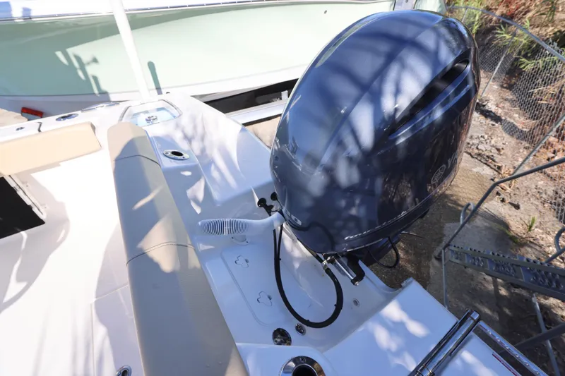 Slide: The Image of 2022 Tidewater 220 CC Adventure boat with Yamaha outboard motor, rear seating area. - 15