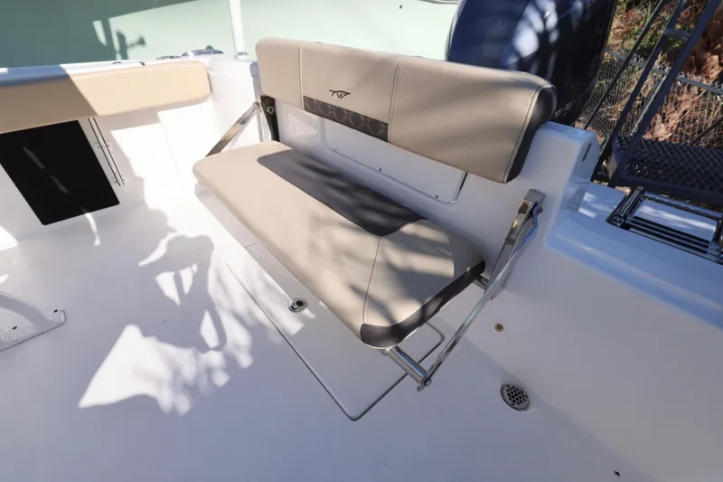 Slide: The Image of 2022 Tidewater 220 CC Adventure boat seat with beige upholstery and foldable design. - 18