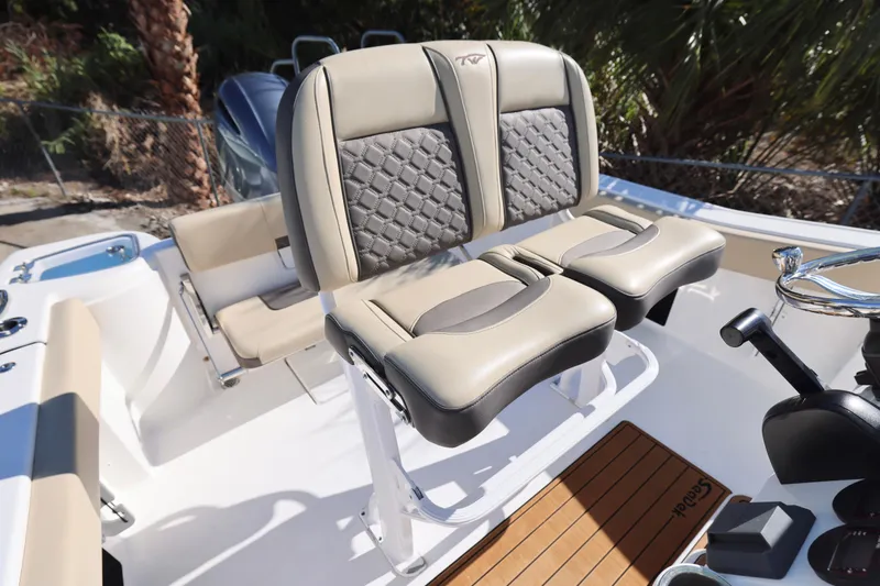 Slide: The Image of 2022 Tidewater 220 CC Adventure boat with stylish dual captain's seats and modern helm. - 20