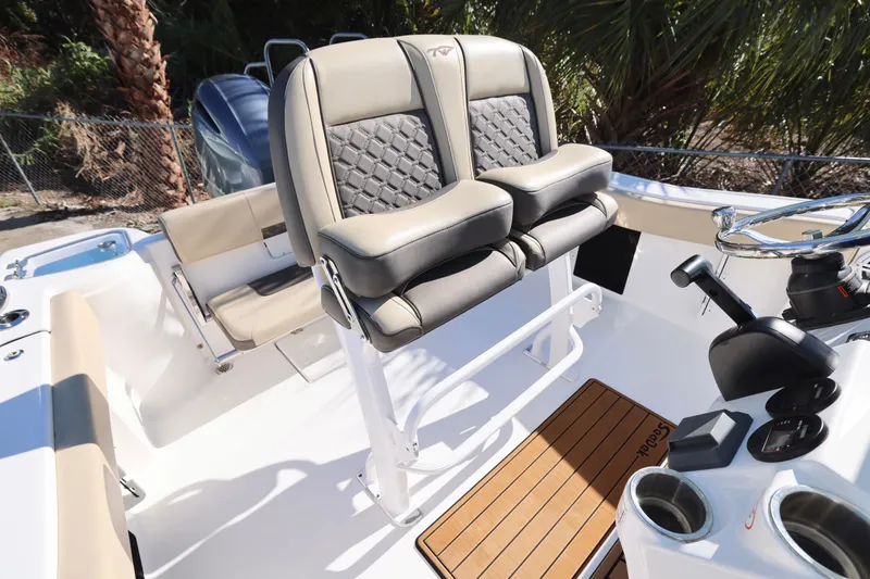 Slide: The Image of 2022 Tidewater 220 CC Adventure boat interior with dual seats and steering console. - 21